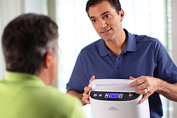 COPD Patient being trained how to maintain the SimplyGo Portable oxygen concentrator