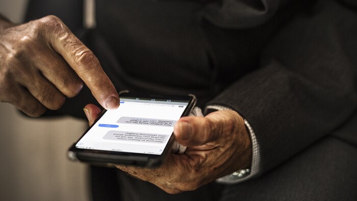 Patient checking hospital appointment reminder text messages on a smart phone