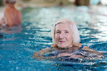 Head shot of lady swimming in a pool