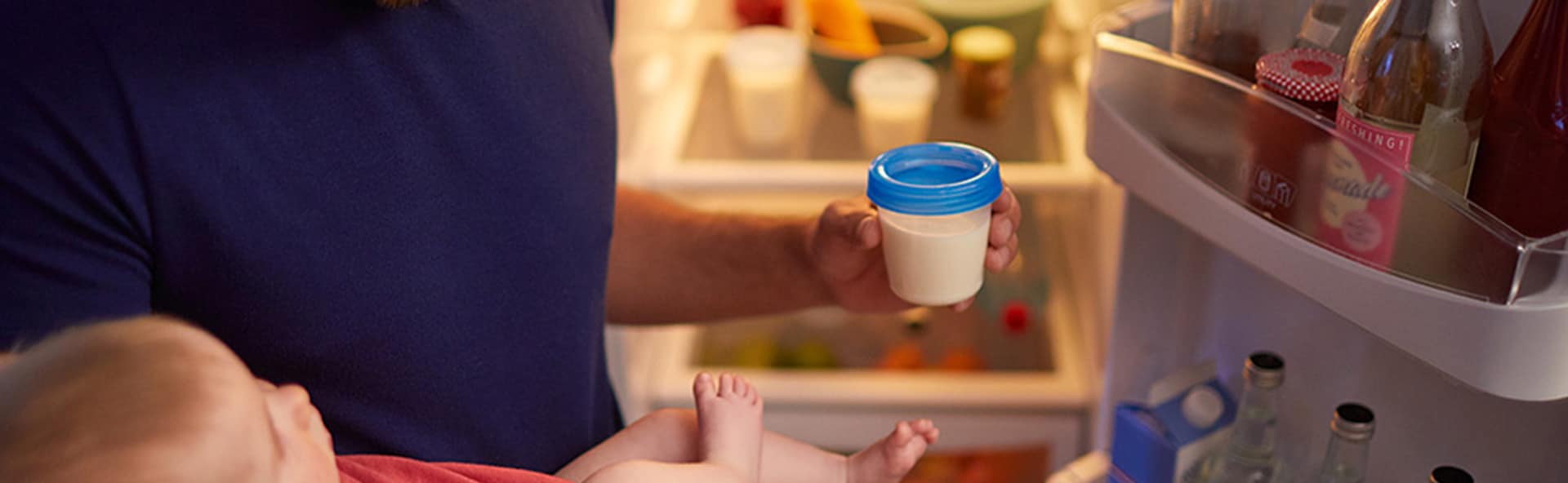 Ein Vater lagert Muttermilch im Kühlschrank