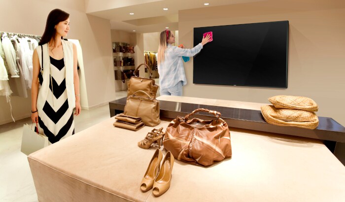 lady cleaning the retail shop tv