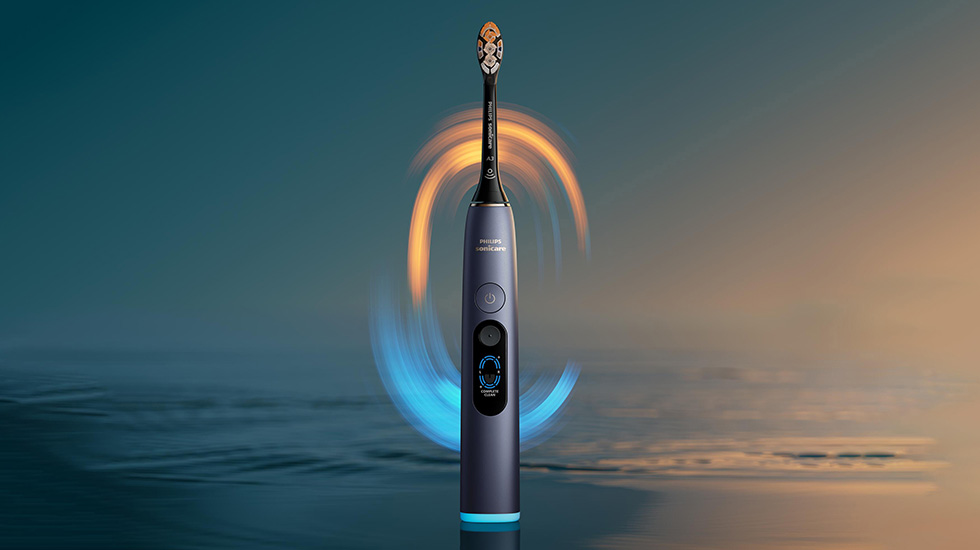 Person brushing with the Philips Sonicare Next-Generation DiamondClean 9900 Prestige using smart pressure feedback.